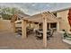 This covered outdoor kitchen and patio area provides ample space for dining and entertaining at 6206 W Buckhorn Trl, Phoenix, AZ 85083