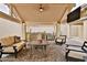 Outdoor covered patio features a full kitchen, comfortable seating, and tv for entertaining guests at 6206 W Buckhorn Trl, Phoenix, AZ 85083