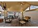 Spacious covered patio with lounge seating, perfect for relaxation, and complete with TV at 6206 W Buckhorn Trl, Phoenix, AZ 85083