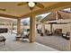 Covered patio with comfortable seating and view of the outdoor kitchen and pool area at 6206 W Buckhorn Trl, Phoenix, AZ 85083