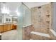 Modern bathroom with a spacious tiled shower featuring a glass partition, bench seat, and showerhead at 6206 W Buckhorn Trl, Phoenix, AZ 85083