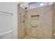 Updated shower with tile surround, built-in niche, grab bars, and accessible shower head at 6206 W Buckhorn Trl, Phoenix, AZ 85083