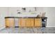 Wet bar with wood cabinets, dark countertop, shelving, and wine fridge for entertaining at 6206 W Buckhorn Trl, Phoenix, AZ 85083