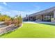 Expansive backyard featuring a pool, patio, manicured lawn, and desert landscaping at 6938 E Lomas Verdes Dr, Scottsdale, AZ 85266