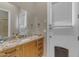 Bathroom with designer granite countertop and sink next to a white door at 6938 E Lomas Verdes Dr, Scottsdale, AZ 85266