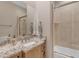 Bathroom with designer granite countertop and a bathtub with a shower at 6938 E Lomas Verdes Dr, Scottsdale, AZ 85266