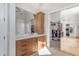 Bathroom featuring light wood cabinets, white marble countertop and access to closet at 6938 E Lomas Verdes Dr, Scottsdale, AZ 85266
