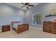 Traditional bedroom with carpet, ceiling fan, window and wooden bed with matching dresser at 6938 E Lomas Verdes Dr, Scottsdale, AZ 85266