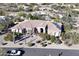 Inviting home featuring desert landscaping, brick accents, an arched entryway, and solar panels at 6938 E Lomas Verdes Dr, Scottsdale, AZ 85266
