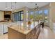 Large kitchen island with stainless appliances and a spacious sunroom at 6938 E Lomas Verdes Dr, Scottsdale, AZ 85266