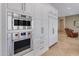 Custom stainless steel appliances, modern oven and freezer, and access to living area at 6938 E Lomas Verdes Dr, Scottsdale, AZ 85266