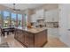 Kitchen with large wood island, white cabinets, and outdoor views at 6938 E Lomas Verdes Dr, Scottsdale, AZ 85266