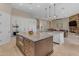 Open kitchen with twin islands, stainless appliances, and access to the living area at 6938 E Lomas Verdes Dr, Scottsdale, AZ 85266