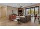 Spacious living room featuring a cozy fireplace, elegant furniture, and sliding doors to the patio at 6938 E Lomas Verdes Dr, Scottsdale, AZ 85266