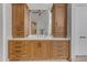 Main bathroom vanity area featuring natural wood cabinetry, dual sinks, and ample storage at 6938 E Lomas Verdes Dr, Scottsdale, AZ 85266