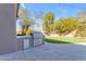 Outdoor kitchen with stainless steel grill, built-in counter, and manicured lawn at 6938 E Lomas Verdes Dr, Scottsdale, AZ 85266