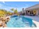 Inviting pool area with waterfall feature and mature landscaping at 6938 E Lomas Verdes Dr, Scottsdale, AZ 85266