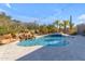 Sparkling swimming pool with rock waterfall and lush desert landscaping at 6938 E Lomas Verdes Dr, Scottsdale, AZ 85266