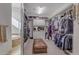 Large walk-in closet with custom shelving, storage, and access to the bathroom at 6938 E Lomas Verdes Dr, Scottsdale, AZ 85266
