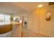 Hallway with kitchen bar, stone accent wall, mirror, and access to a bedroom at 805 N 4Th Ave # 903, Phoenix, AZ 85003