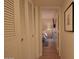 Hallway with closet leading to a bedroom with a lamp and TV at 805 N 4Th Ave # 903, Phoenix, AZ 85003