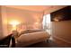 Well-lit main bedroom features a modern bed, bedside table, balcony access, and a mounted flatscreen TV at 805 N 4Th Ave # 903, Phoenix, AZ 85003