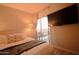 Well-lit main bedroom features a modern bed, bedside table, balcony access, and a mounted flatscreen TV at 805 N 4Th Ave # 903, Phoenix, AZ 85003