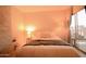 Sun-filled main bedroom showcases a bed, bedside table, balcony access, and decorative stone wall at 805 N 4Th Ave # 903, Phoenix, AZ 85003