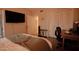 A view of the main bedroom featuring a closet, mounted flatscreen TV, and workspace at 805 N 4Th Ave # 903, Phoenix, AZ 85003