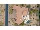 Aerial of an estate home featuring lush desert landscaping, pool, and a cozy outdoor patio at 9161 E Superstition Mountain Dr, Gold Canyon, AZ 85118