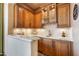 A well-appointed wet bar featuring custom cabinets, granite countertop, and glass rack at 9161 E Superstition Mountain Dr, Gold Canyon, AZ 85118