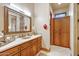Bathroom with a large mirror over double sinks and lots of cabinet space at 9161 E Superstition Mountain Dr, Gold Canyon, AZ 85118