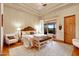 Bedroom with hardwood floors, a tray ceiling and direct access to the outdoor living area at 9161 E Superstition Mountain Dr, Gold Canyon, AZ 85118