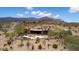 Expansive estate home nestled in a scenic desert landscape overlooking a custom pool and outdoor living area at 9161 E Superstition Mountain Dr, Gold Canyon, AZ 85118