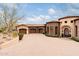 Exterior of home shows the three car garage and front entry with brick driveway at 9161 E Superstition Mountain Dr, Gold Canyon, AZ 85118