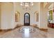 Elegant foyer features hardwood floors, detailed ceiling and custom ironwork door at 9161 E Superstition Mountain Dr, Gold Canyon, AZ 85118