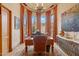 Cozy home office features an elegant desk, piano, large windows, and hardwood floors at 9161 E Superstition Mountain Dr, Gold Canyon, AZ 85118