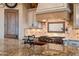 Close up on a kitchen featuring a Wolf range, custom backsplash and granite countertops at 9161 E Superstition Mountain Dr, Gold Canyon, AZ 85118