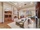 An inviting living room with a fireplace, chandelier, and cozy seating area at 9161 E Superstition Mountain Dr, Gold Canyon, AZ 85118