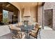 Outdoor dining space with a built-in grill, stainless steel appliances, and a beautiful stone backsplash at 9161 E Superstition Mountain Dr, Gold Canyon, AZ 85118