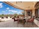 Relaxing outdoor living area with comfortable seating, a fire pit, and views of the surrounding desert landscape at 9161 E Superstition Mountain Dr, Gold Canyon, AZ 85118