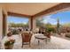 Covered outdoor patio with comfortable seating, desert views and tiled flooring at 9161 E Superstition Mountain Dr, Gold Canyon, AZ 85118