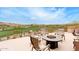 Outdoor patio with comfortable seating and fire pit, perfect for enjoying views of the golf course and desert landscape at 9161 E Superstition Mountain Dr, Gold Canyon, AZ 85118