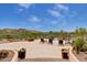 Resort-style pool area with lush landscaping, a waterfall feature, and comfortable lounge chairs at 9161 E Superstition Mountain Dr, Gold Canyon, AZ 85118