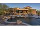 An expansive backyard features a pool with a waterfall and spa, plus plenty of room for lounging and entertaining at 9161 E Superstition Mountain Dr, Gold Canyon, AZ 85118