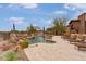 Inviting pool with rock waterfall feature, surrounded by lush landscaping and comfortable lounge chairs at 9161 E Superstition Mountain Dr, Gold Canyon, AZ 85118