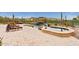 Backyard oasis with a custom pool, rock waterfall, spa, and desert landscaping, perfect for relaxation at 9161 E Superstition Mountain Dr, Gold Canyon, AZ 85118