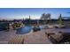 Backyard pool with waterfall and desert views provides a serene setting at 9161 E Superstition Mountain Dr, Gold Canyon, AZ 85118