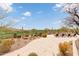 Scenic view of the pool and backyard, surrounded by desert landscaping and a lush green golf course at 9161 E Superstition Mountain Dr, Gold Canyon, AZ 85118