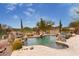 Backyard pool with a stone waterfall feature, desert plants, and views of the surrounding neighborhood at 9161 E Superstition Mountain Dr, Gold Canyon, AZ 85118